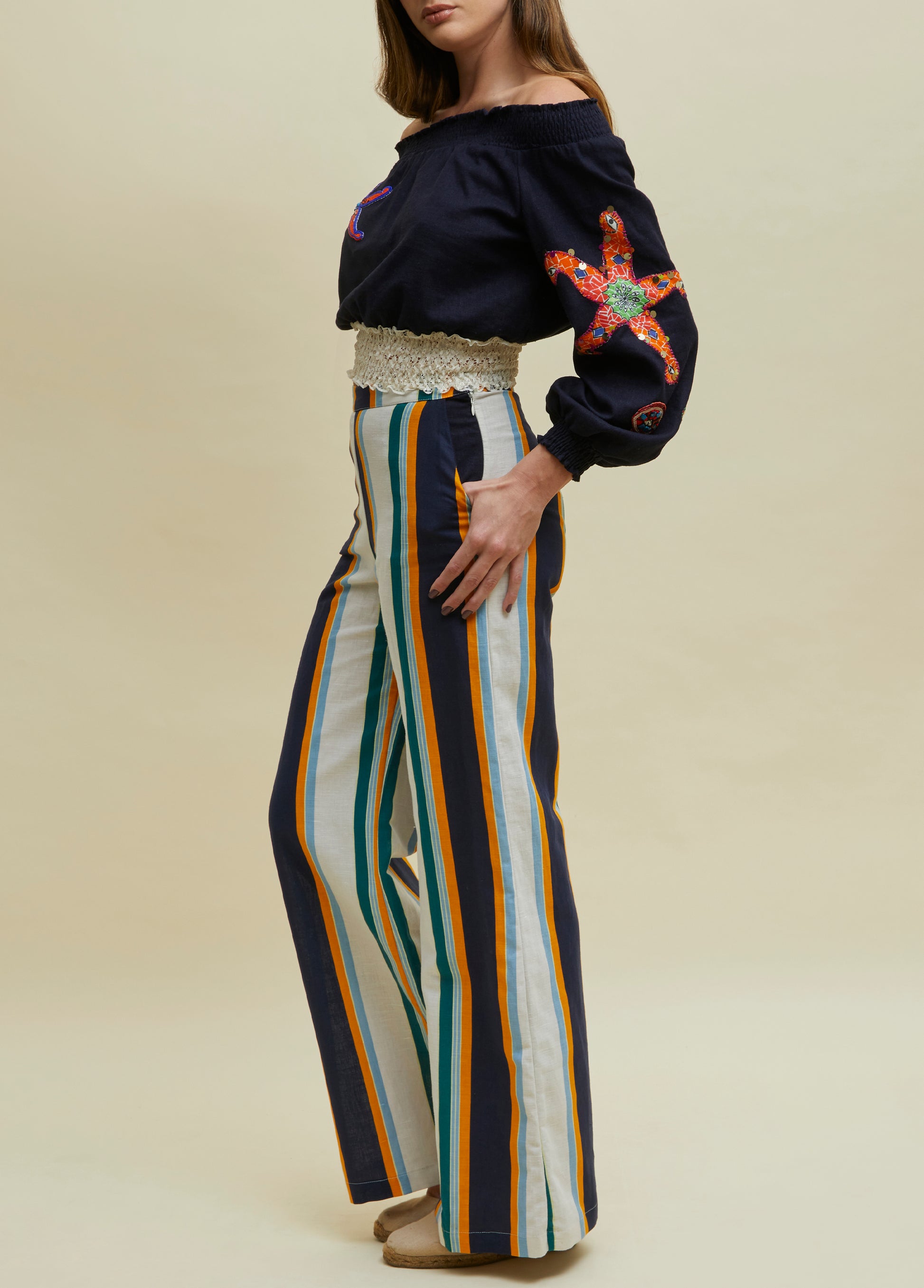 linen top in blue with coral embroideries hand made worn with striped pants in blue orange beige turquoise by atelier ferdinando fusco
